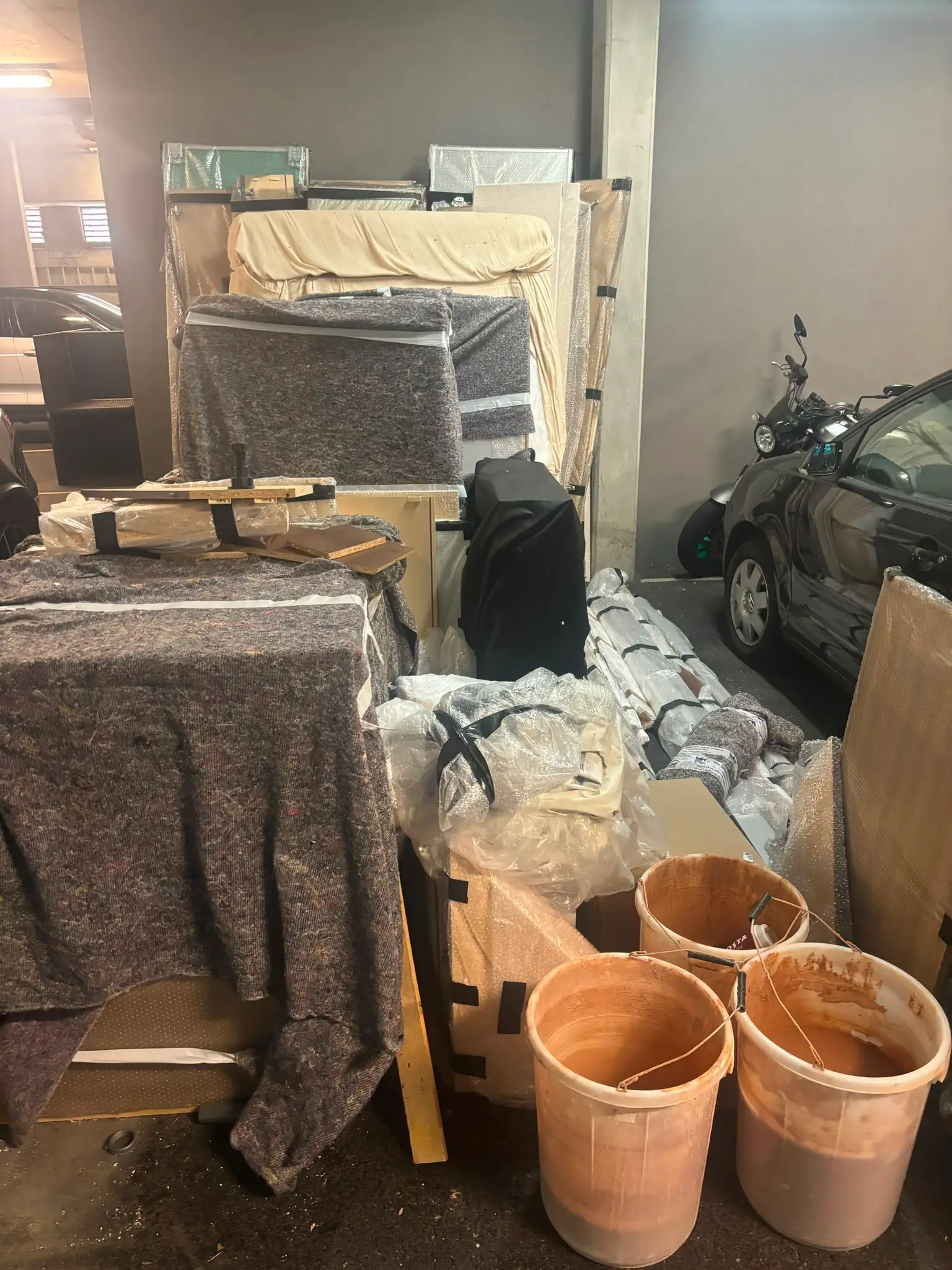 Garage storage area containing household belongings before clearance.