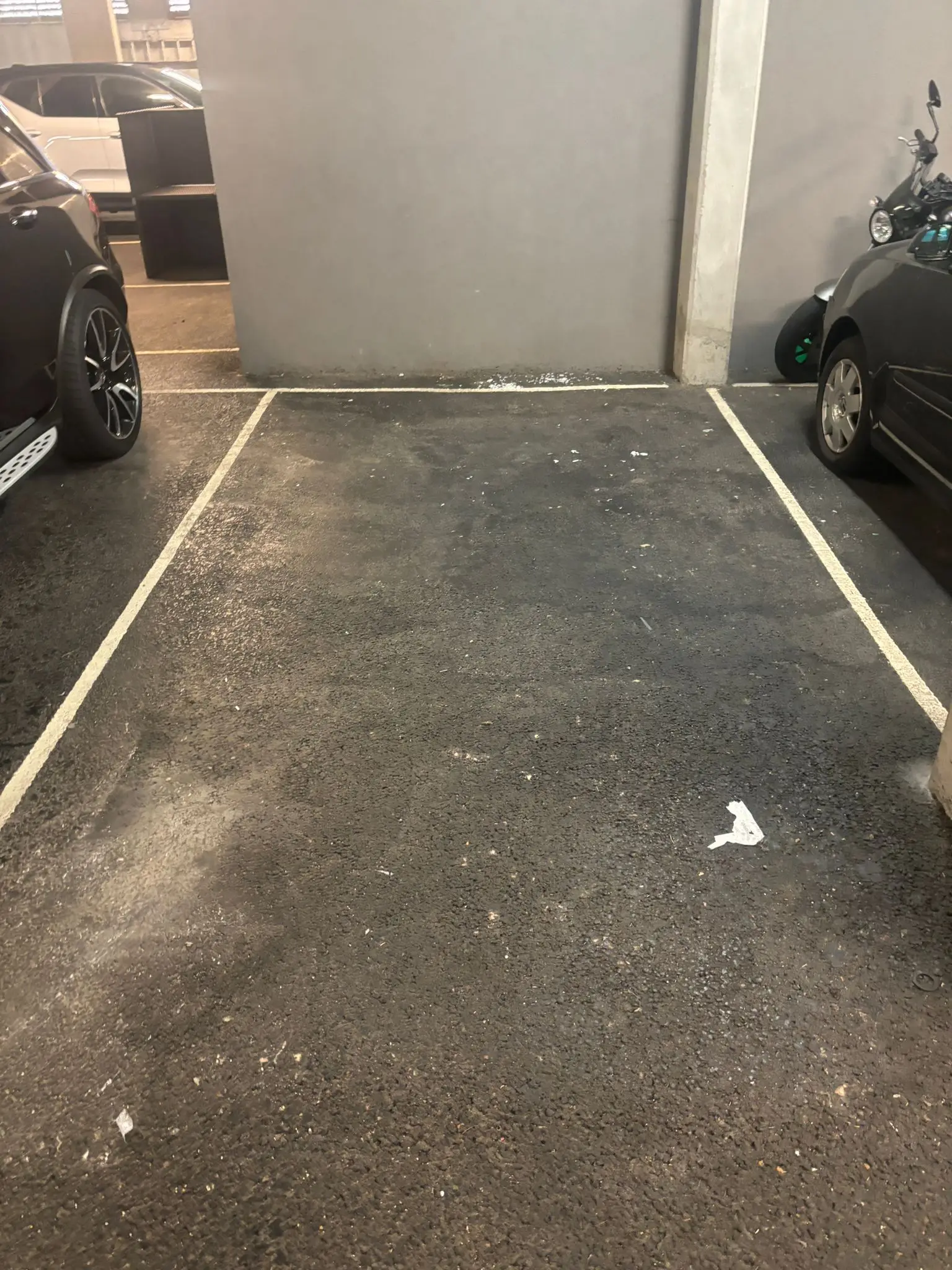 Empty parking bay after stored furniture and equipment have been removed.