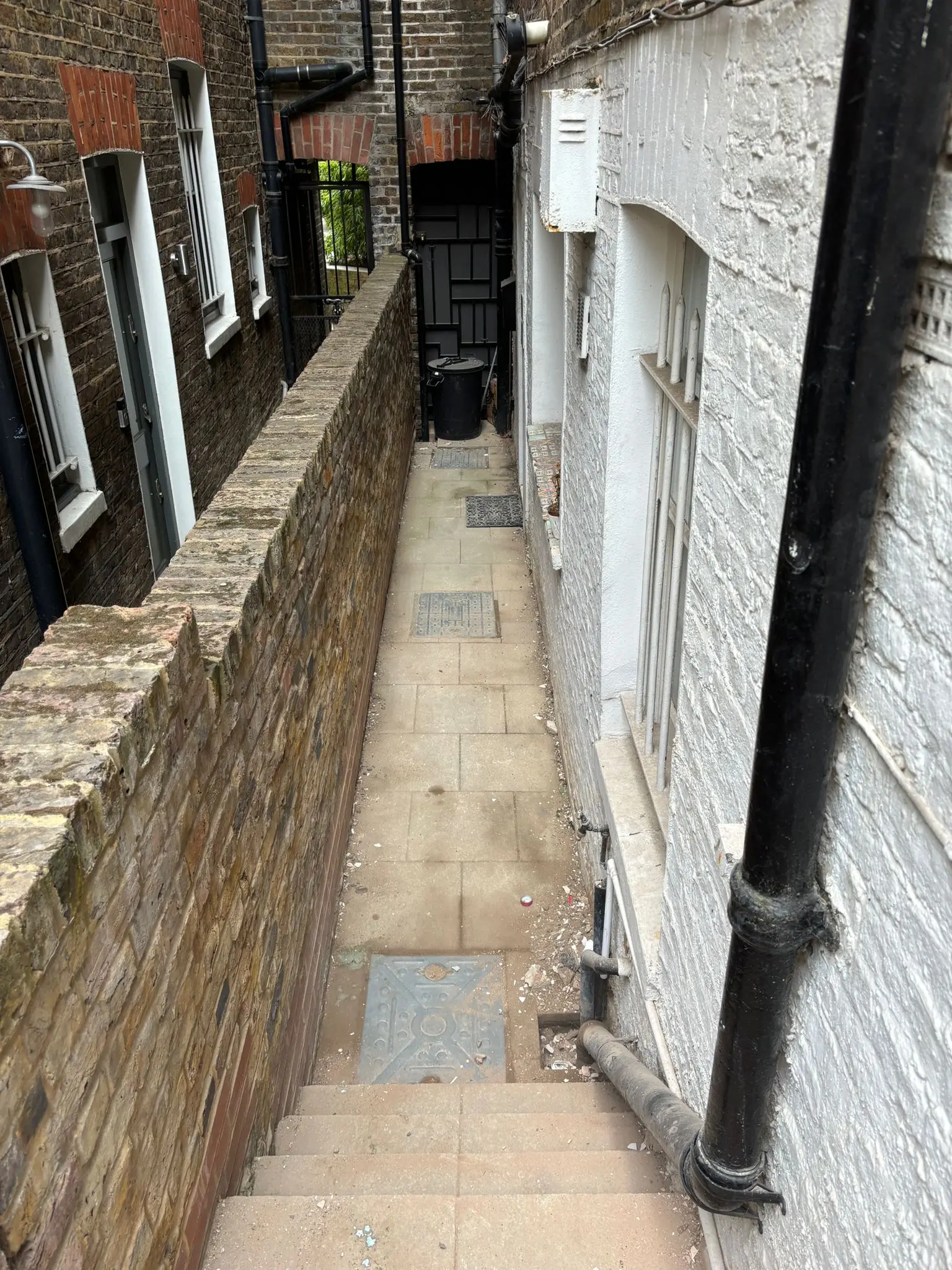 Side passage after rubble, plasterboard and builders waste have been removed.