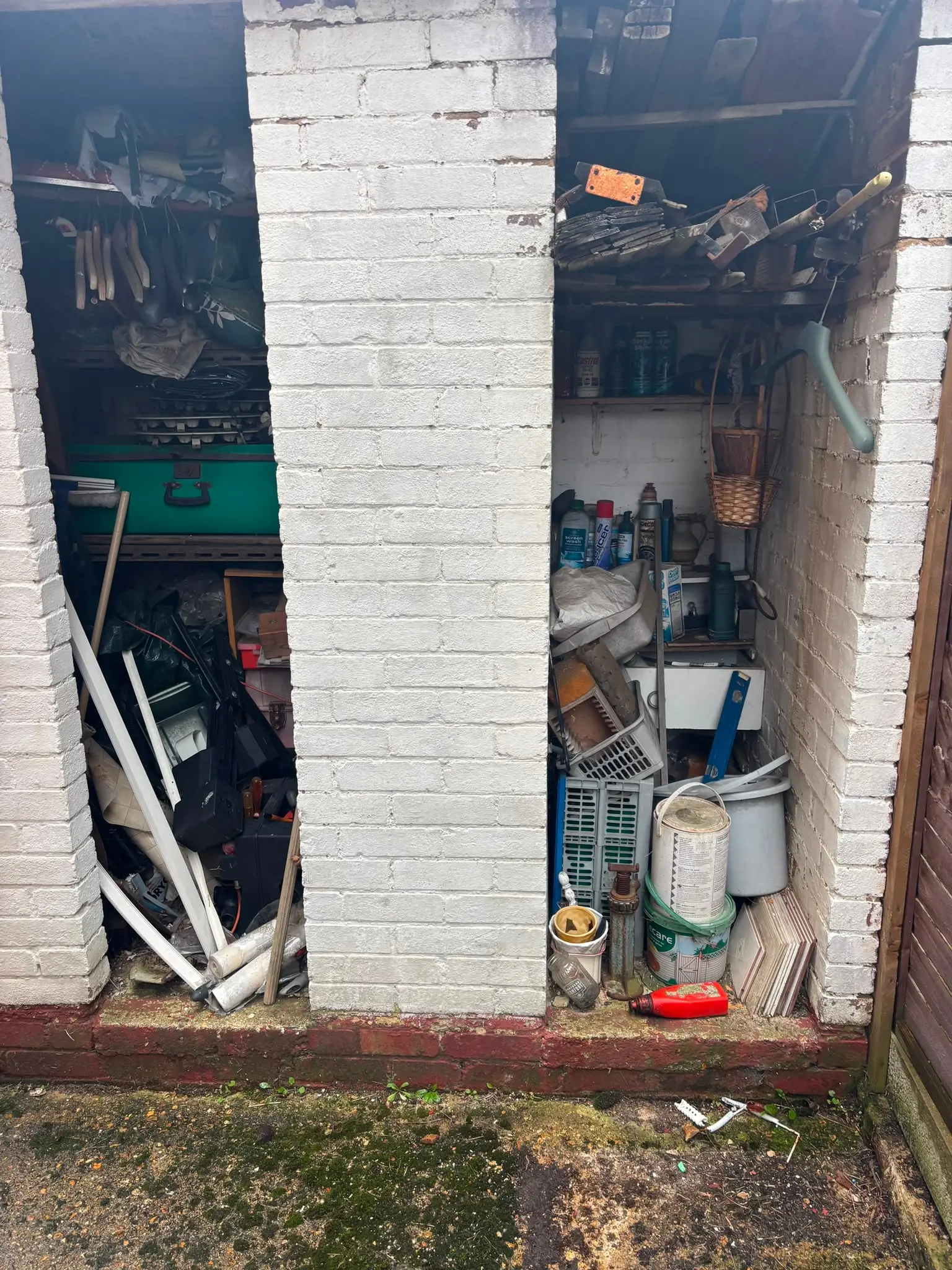 Garage or outbuilding filled with stored items before a clearance.